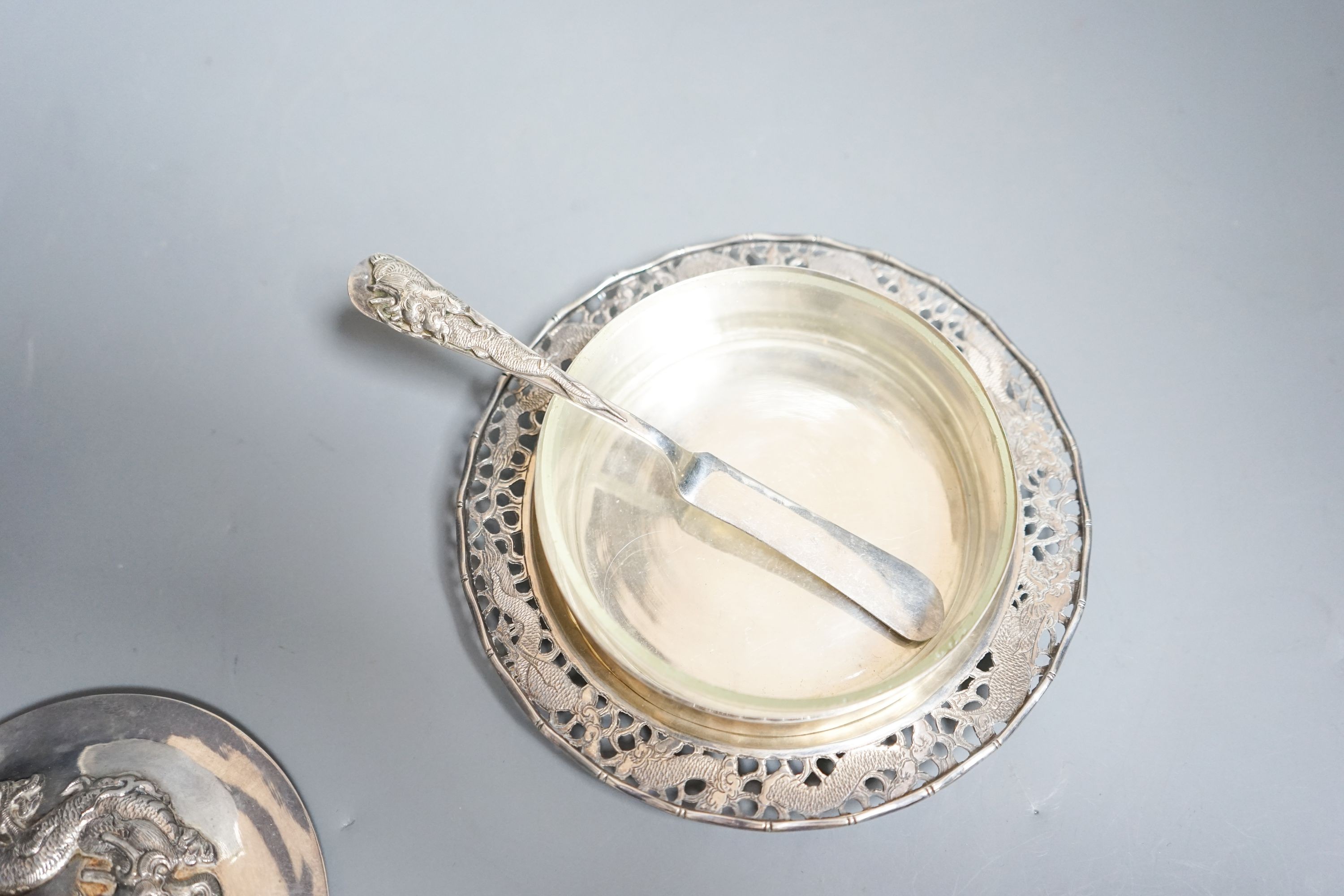 A Chinese white metal butter dish, on stand with knife by Tack Hing, with glass liner, 14.2cm.